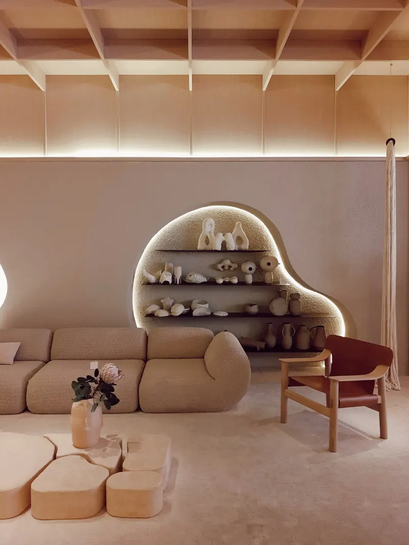 Curved sofa beneath arched alcove shelving