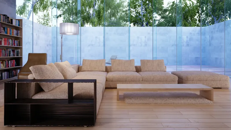 Lounge with a low sectional sofa and full-height glass wall