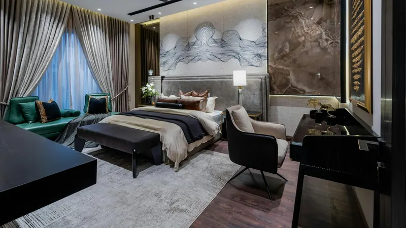 Bedroom with stone-look feature wall and velvet seating