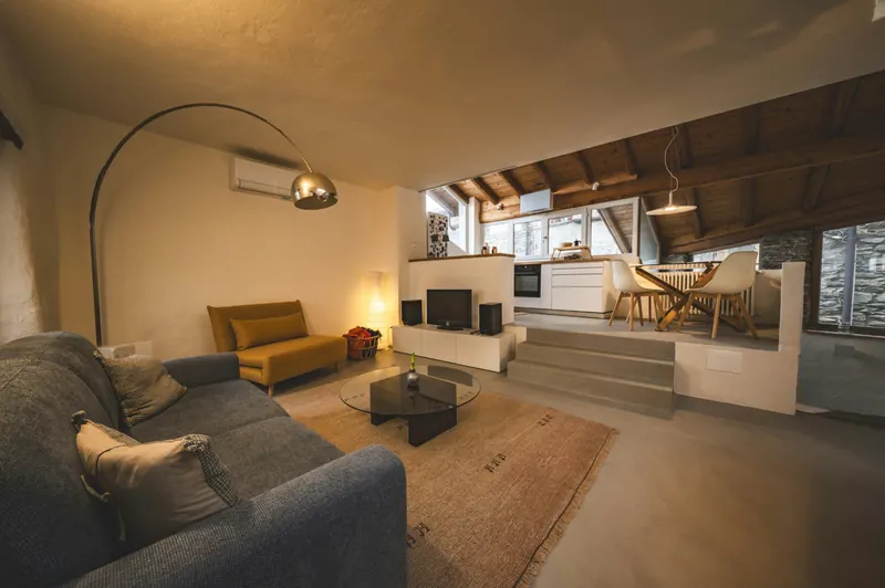 Open living room with arc lamp and timber ceiling
